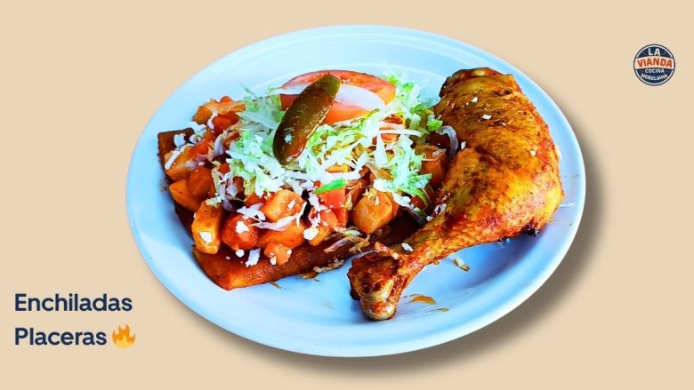 Plate with a roasted chicken leg beside potato hash topped with shredded cabbage and a jalapeño, on a blue plate; labeled 'Enchiladas Placeras'.